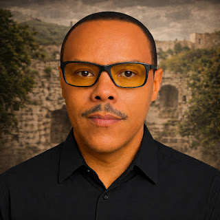 A man wearing glasses, identified as Missionary John, poses for a profile image.